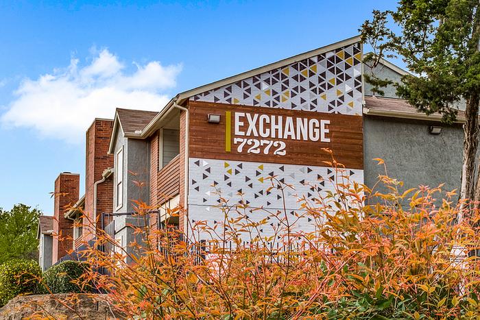 Charming apartment exterior with unique geometric design and lush greenery at 'Exchange 7272'.