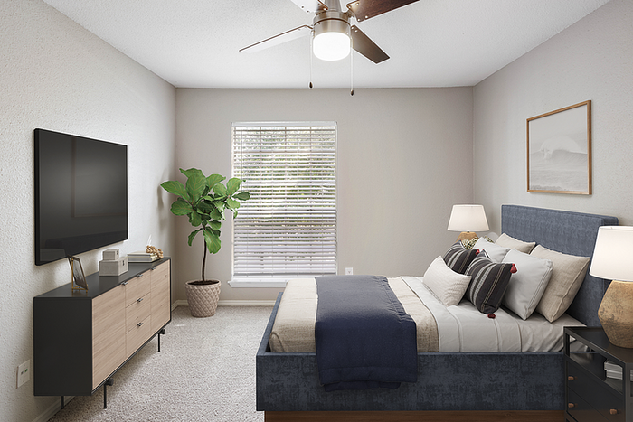 Sophisticated bedroom with a plush bed, elegant decor, ample natural light, and modern furnishings.