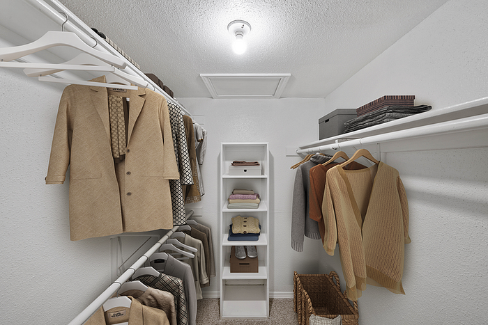 Spacious walk-in closet with elegant shelving, ample hanging space, and neatly organized clothing and accessories.