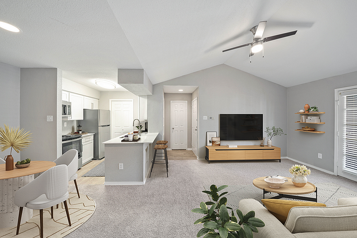 Bright and inviting open-concept living area with modern kitchen, cozy dining space, and stylish living room, perfect for entertaining.