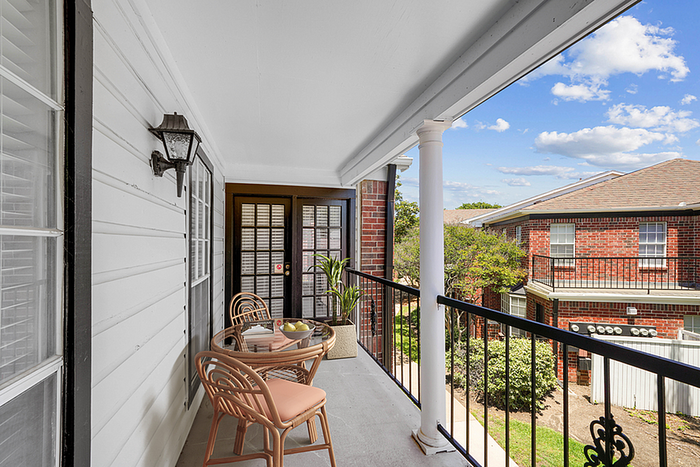 Charming balcony with stylish seating and a stunning view, perfect for relaxing and enjoying the outdoor ambiance.