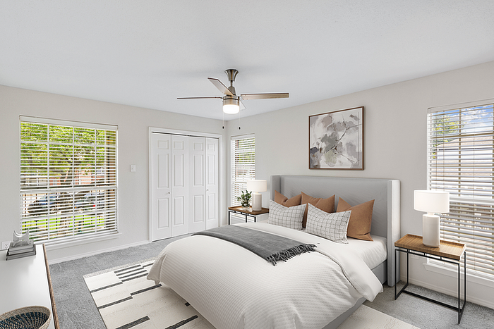 Bright and spacious bedroom with large windows, modern decor, and a cozy atmosphere, perfect for relaxation.