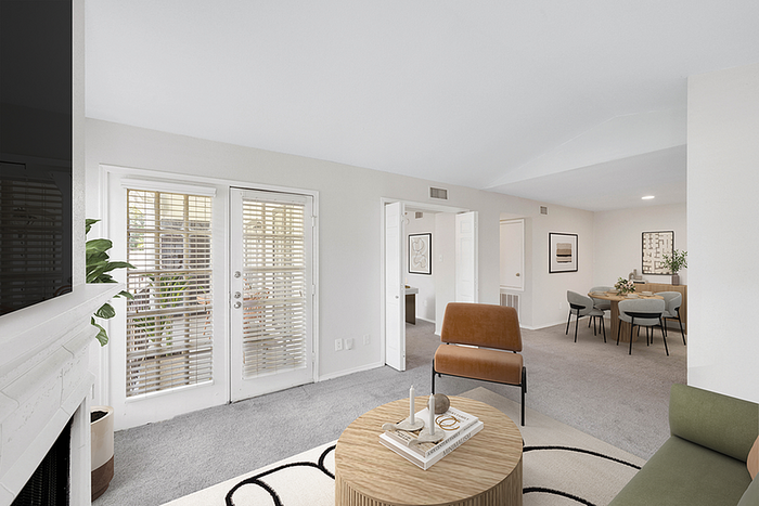 Bright and inviting living room with elegant decor, plush seating, and a view into a stylish dining area, perfect for entertaining.