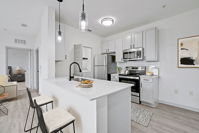Contemporary kitchen with sleek white cabinets, modern appliances, and a spacious island perfect for entertaining.