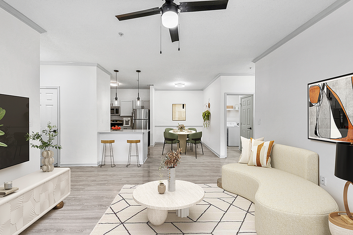 Modern open-concept living area with stylish furniture, sleek kitchen, and cozy dining space, perfect for contemporary living.