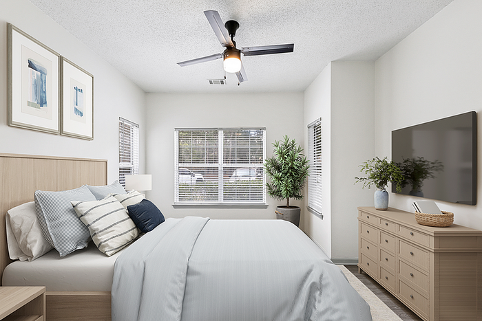 Bright and inviting bedroom with stylish decor, featuring a cozy bed with plush pillows, modern artwork on the walls, and a soothing natural light flowing through large windows.