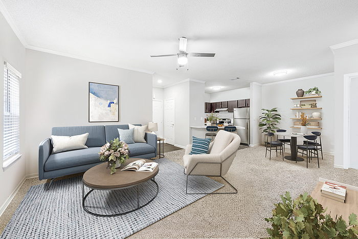 Modern open-concept living room and dining area with elegant decor, stylish furniture, and a sleek, fully-equipped kitchen.
