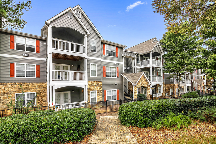 Charming apartment community with modern architectural design, inviting balconies, and lush landscaping.