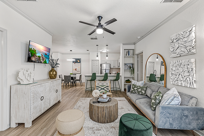 Contemporary open-concept living space featuring elegant decor, plush seating, and a tranquil dining area leading to a sleek modern kitchen.