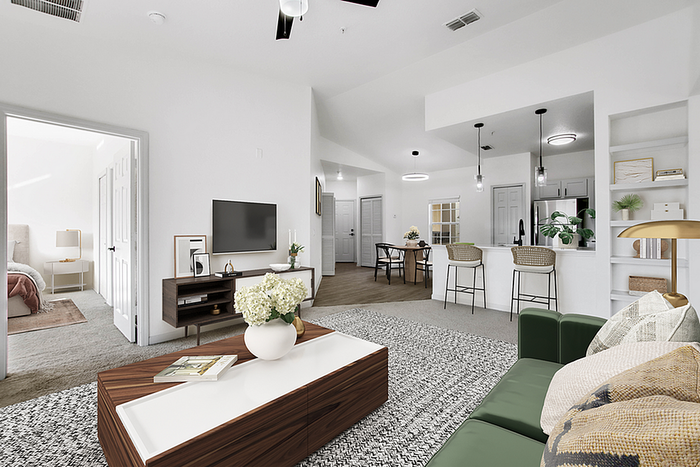 Elegant open-concept living space featuring a cozy seating area, modern kitchen with bar stools, and a view into a tranquil bedroom.