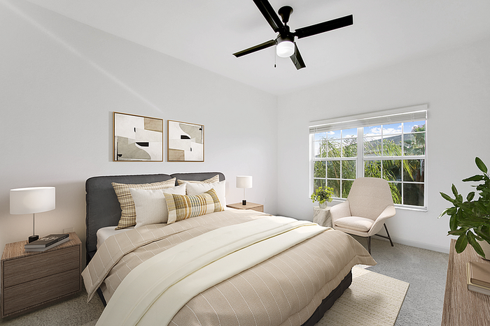Bright and inviting bedroom with contemporary decor, large window with lush greenery view, and elegant furnishings including a cozy armchair and stylish artwork.