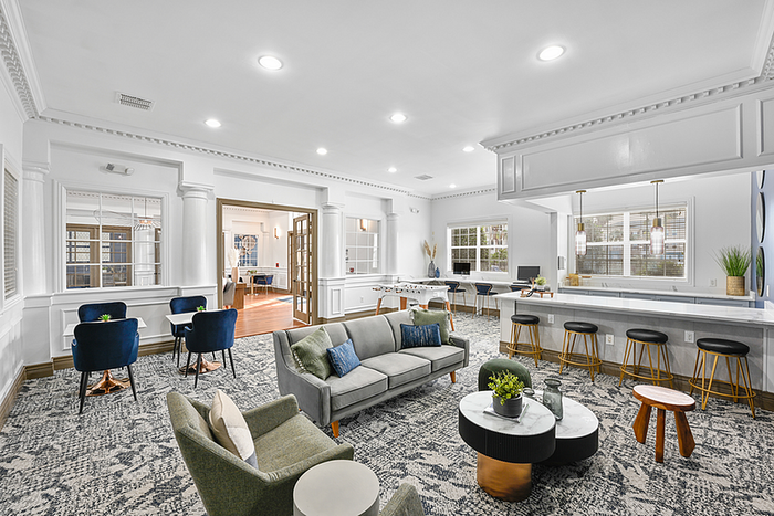 Clubhouse lounge area with elegant seating, modern decor, and ample natural light perfect for relaxation and socializing.