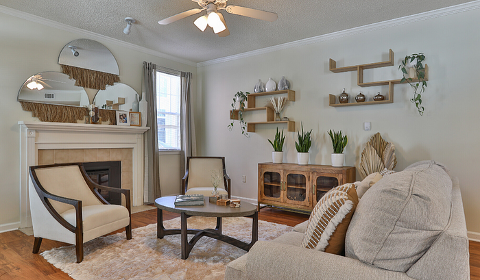 Inviting living room with modern decor, featuring cozy seating, elegant fireplace, and vibrant greenery.