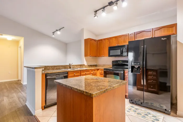 Classic kitchen equipped with full-size appliances, thoughtful space planning a floating island, and ample lighting.