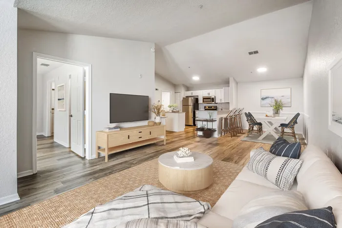 Spacious living room with ample room for seating, natural sunlight, and modern finishes.