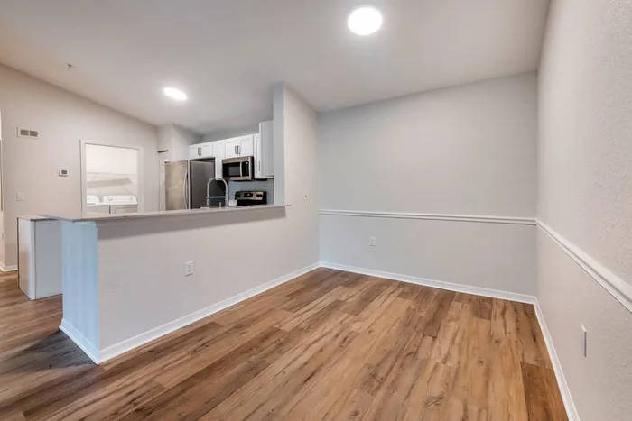 Spacious dining room with ample room for seating, natural sunlight, and modern finishes.