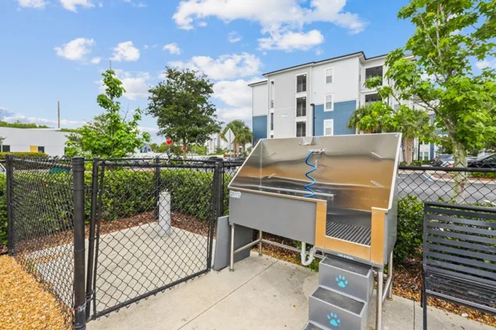 Outdoor Pet Spa with a professional grooming faucet at Lantower Asturia Apartments.