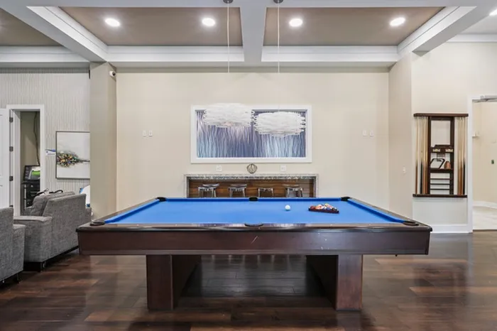 Game room with a billiard table and a seating area at Lantower Asturia Apartments.