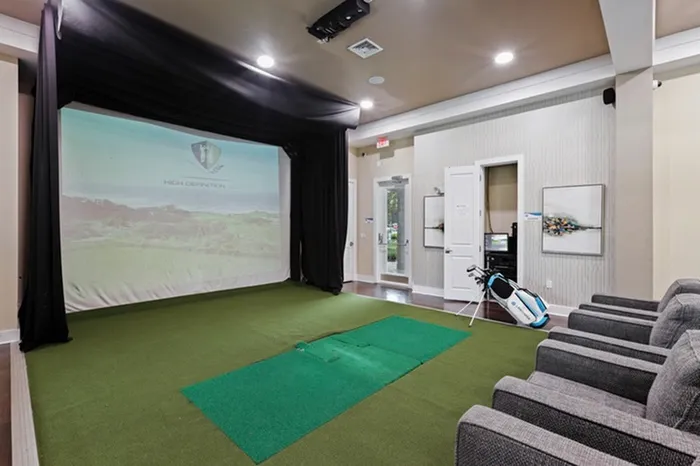 Virtual, PGA-Quality Golf Simulator with artificial grass and a viewing area at Lantower Asturia Apartments.