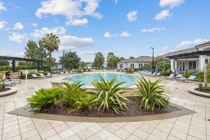 Resort-style pool with sundeck and lounge chairs at Lantower Asturia.