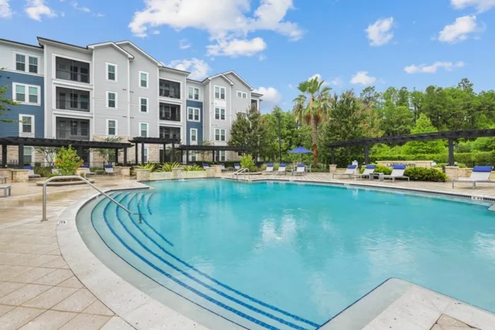 Resort-style pool with sundeck and lounge chairs at Lantower Asturia.