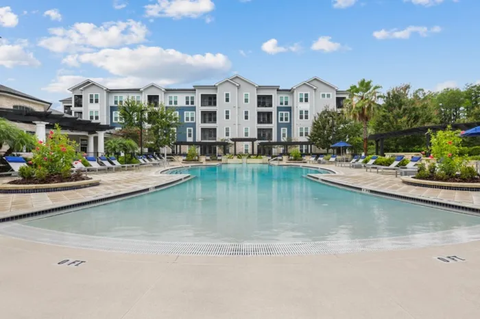 Resort-style pool with sundeck and lounge chairs at Lantower Asturia.
