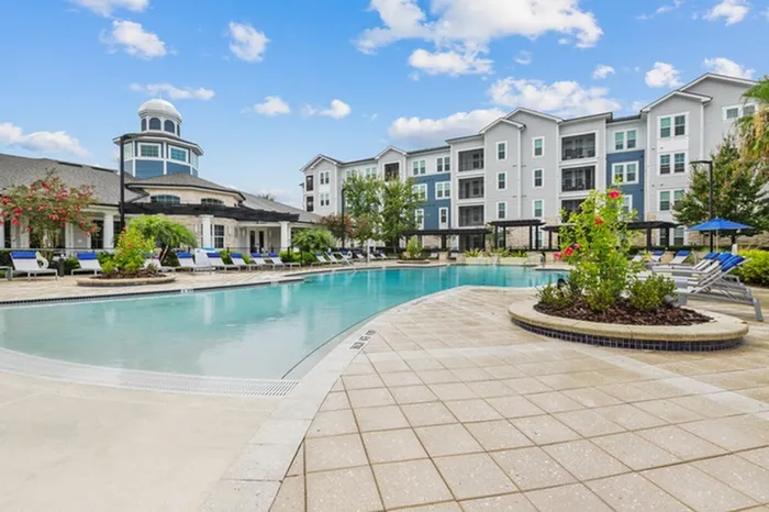 Resort-style pool with sundeck and lounge chairs at Lantower Asturia.