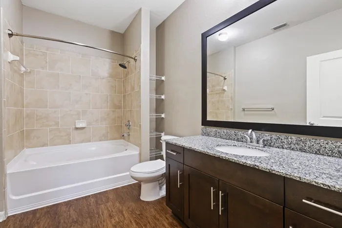Bathroom with grey, granite countertops and a storage shelf at Lantower Asturia.