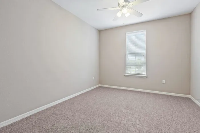 Carpeted bedroom with a large window at Lantower Asturia