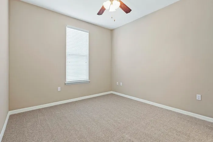 Bedroom with carpet, a ceiling fan, and a large window at Lantower Asturia.