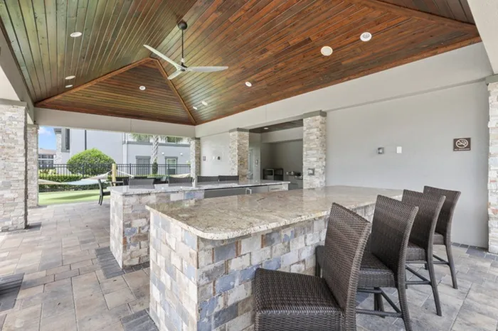 A covered veranda with ample seating, a restroom, water fountain, and mini fridge at Lantower Grand Pines