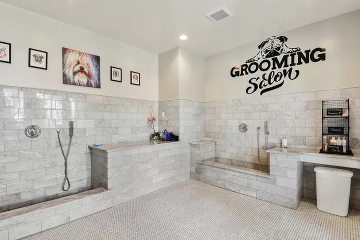 Pet grooming area tiled with brick, with two dog showers at Lantower Edgewater