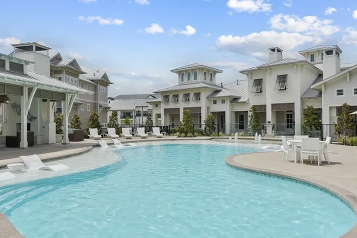 Large pool surrounded by pool chairs at Lantower Edgewater