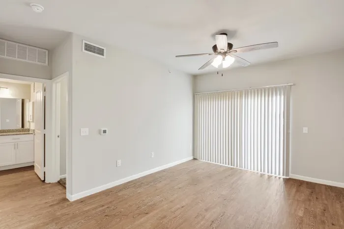 Spacious living room with hardwood floors and a ceiling fan at Lantower Edgewater