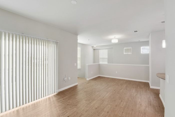 Spacious living room with faux wood flooring and natural lighting at Lantower Edgewater