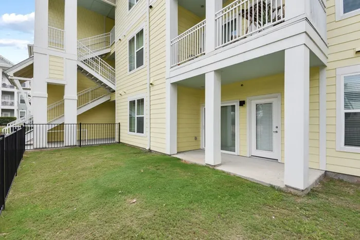 Rectangular grass yard, fenced in with access from Lantower Edgewater