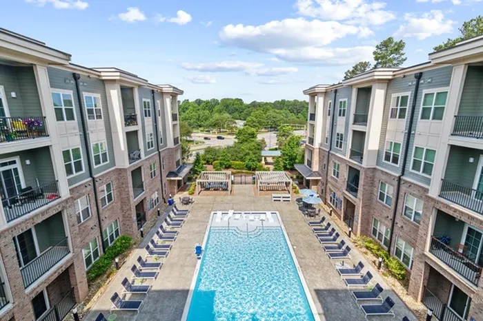 Pool with Sundeck & Outdoor Kitchen with lounge chairs at Lantower Weston Corners.