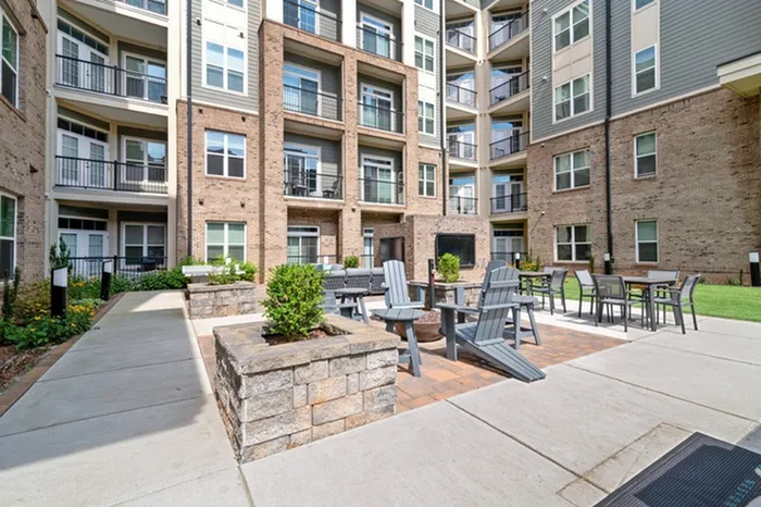 Courtyard with lounge chairs and gas firepits at Lantower Weston Corners.