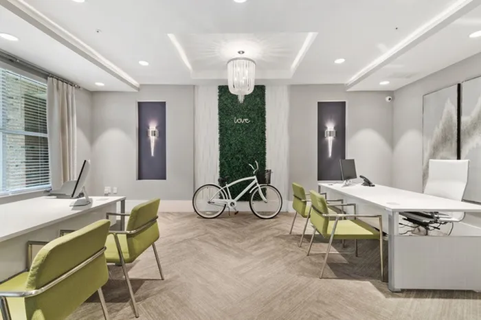 Office with green accents and iMac computers at Lantower Weston Corners.