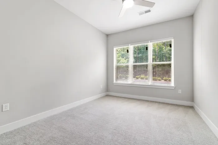 Carpeted, spacious bedroom with cream walls at Lantower Weston Corners.