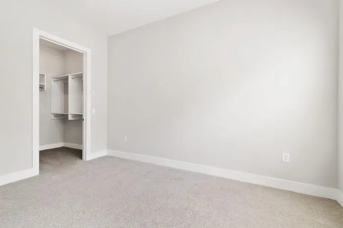 Carpeted, spacious bedroom with cream walls at Lantower Weston Corners.
