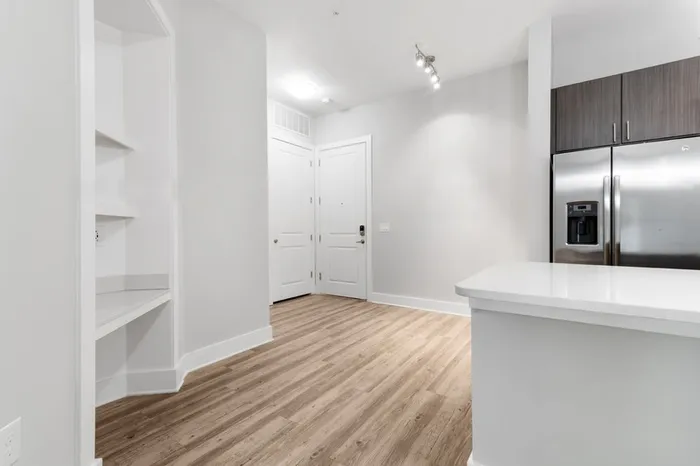 Apartment entrance with a kitchen island and space for a kitchen table at Lantower Weston Corners.