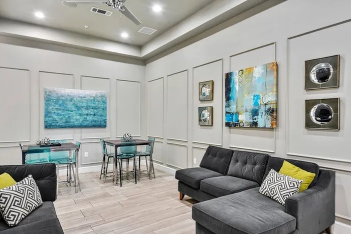 Modern lounging area with a thoughtfully placed artwork, cozy sofas, and dining tables at Lantower Techridge