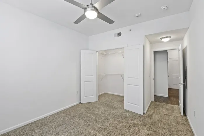 Bedroom with carpet flooring, walk-in closet, and ample room for furniture at Lantower Techridge