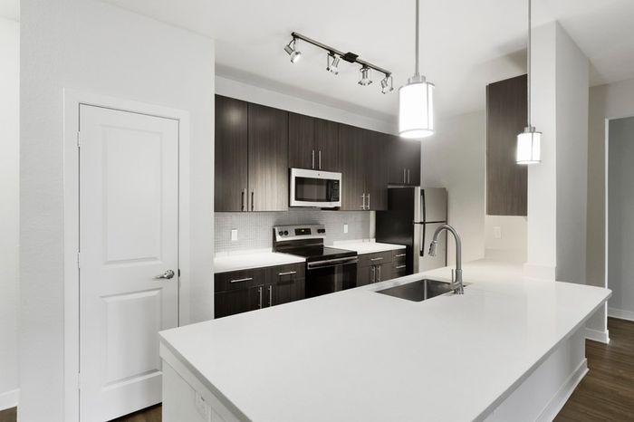 Chef-inspired kitchen with brushed nickel fixtures, 9-foot ceilings, and a kitchen island at Lantower Brandon Crossroads.