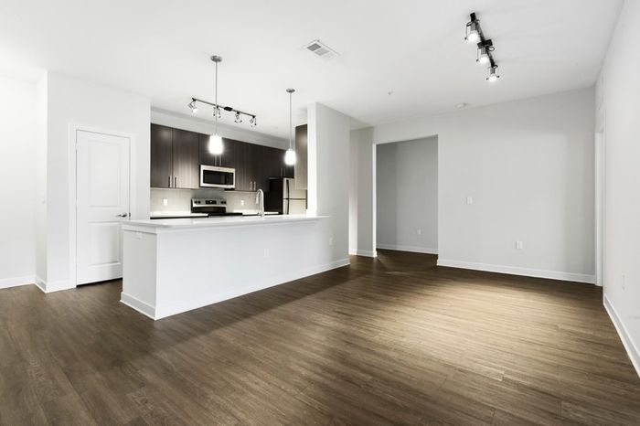 Chef-inspired kitchen with brushed nickel fixtures, and 9-foot ceilings with a spacious living room attached at Lantower Brandon Crossroads.