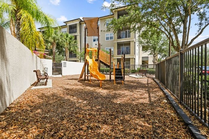 Woodchip playground with a bench and slide at Lantower Brandon Crossroads.