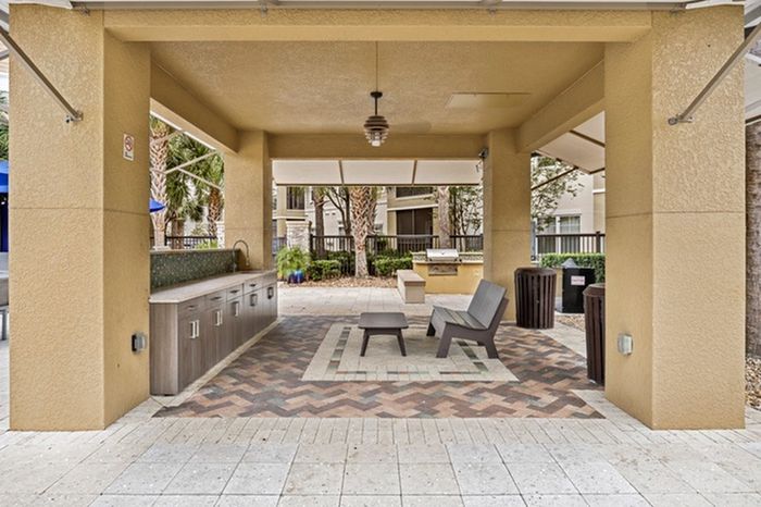 Covered outdoor area with a sink, mini fridge, and seating area at Lantower Brandon Crossroads.