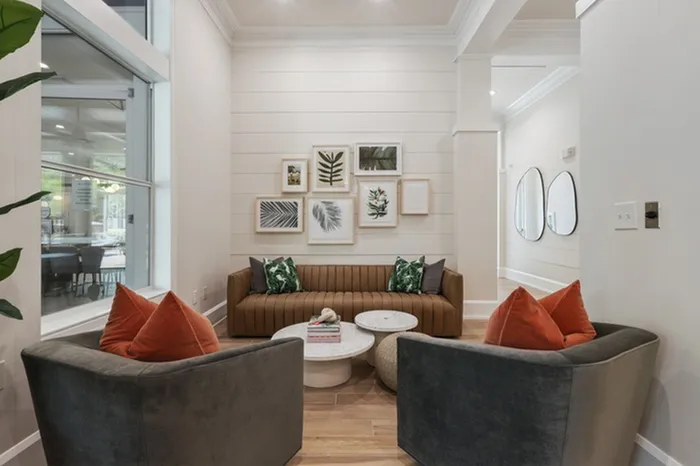Image of seating area with white shiplap, stylish furniture, and trendy wall art.