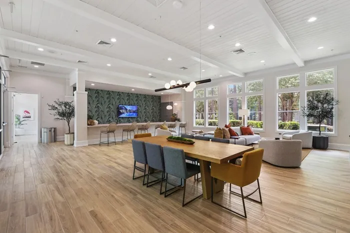 Image of Lantower Cypress Creeks' newly-renovated clubhouse with stylish wallpaper, modern furniture, and ceiling to floor windows with ample natural sunlight.
